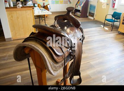 Vintage horse saddle on display at old ranch. Stock Photo