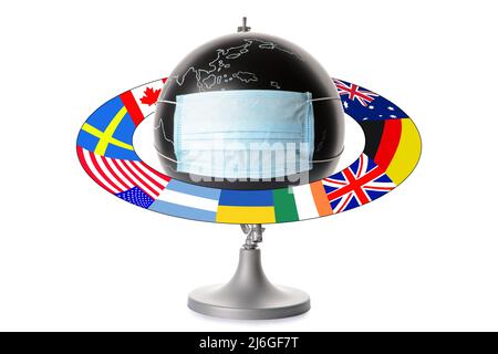 Globe with medical mask and different flags isolated on white. Concept of COVID-19 pandemic Stock Photo