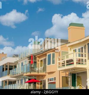 Square White puffy clouds Row of building accommodations at Oceanside, California Stock Photo