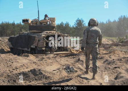 U.S. Army Soldiers assigned to the 3rd Armored Brigade Combat Team, 4th Infantry Division, scouts conduct reconnaissance and security to enable brigade defense at Drawsko Pomorskie, Poland, April 29, 2022. The 3/4 ABCT is among other units assigned to V Corps, America’s forward-deployed corps in Europe that works alongside NATO allies in joint, bilateral, and multinational training exercises. (U.S. Army photo Sgt. Andrew Greenwood) Stock Photo