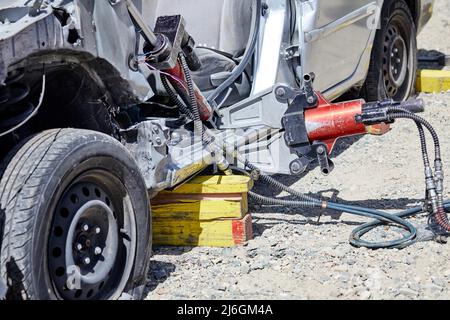 Close up of Fire Fighters using the Jaws of Life to dismantle a car during a demonstration Stock Photo
