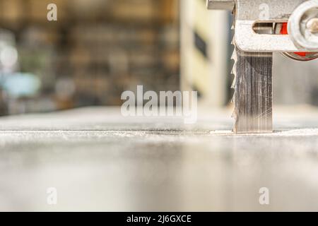 Band saw cutting wood in light workshop Stock Photo