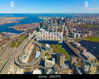 Boston downtown financial district skyline and Leonard Zakim Bridge aerial view, with Boston Harbor and Charles River at the background, Boston, MA Stock Photo