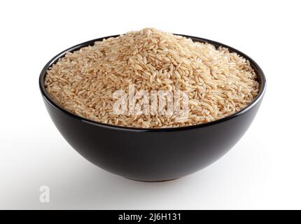 Brown rice in black bowl isolated on white background with clipping path Stock Photo