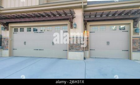Panorama Three car parking garage with double side hinged doors Stock Photo