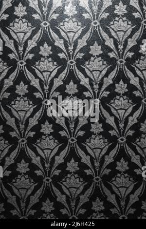 Vintage graphic or texture in steampunk style, light grey vines and leaves on a black background. Vertical photo. Stock Photo