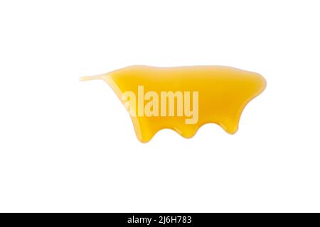 Isolated gold honey melting on white background. Sticky yellow dense liquid flowing. Horizontal Stock Photo