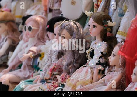 A row of lavishly dressed dolls Stock Photo