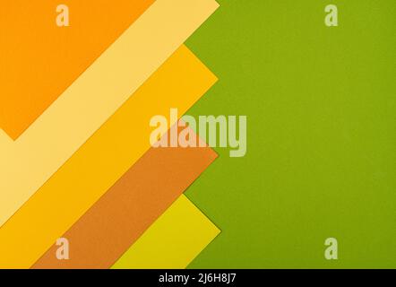 Colorful overlapped orange, yellow and green cardboard layers of paper on background Stock Photo