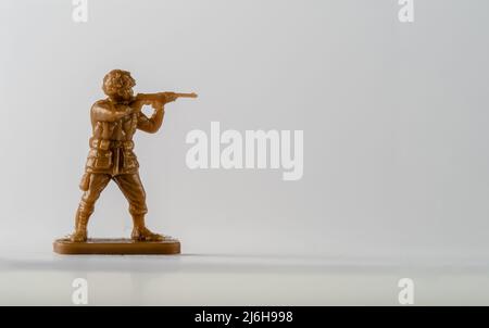 Historical Military soldier toy in brown infantryman with rifle raised to the shoulder Stock Photo