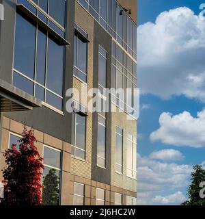 Square White puffy clouds Building facade with bricks, glass and concrete wall cladding du Stock Photo