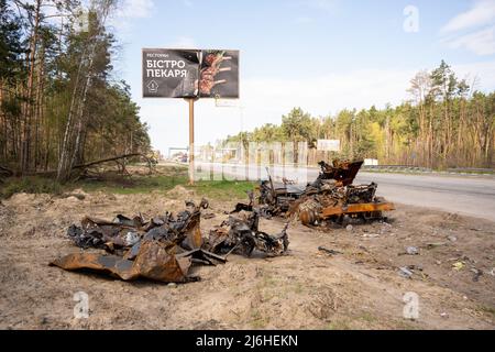 Destroyed truck lays beside one of the main roads into Kyiv in April 2022 Stock Photo