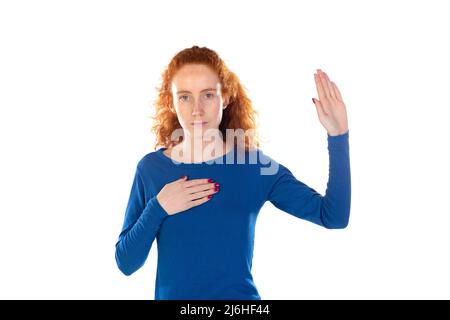 Pretty redhead young woman shows heartfelt gratitude, clasps hands on chest, smiles positively, appreciates received warm words from lover, being very Stock Photo