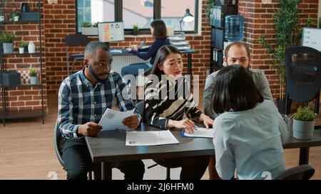 Displeased employee getting fired from business work job, feeling shocked about bad news and unemployment. Jobless upset woman being dismissed from corporate and human resources career. Stock Photo