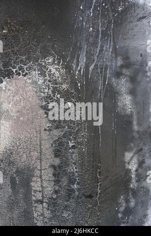 burnt and dirty metal surface in gray tones as a rough full frame background texture, copy space, selected focus Stock Photo