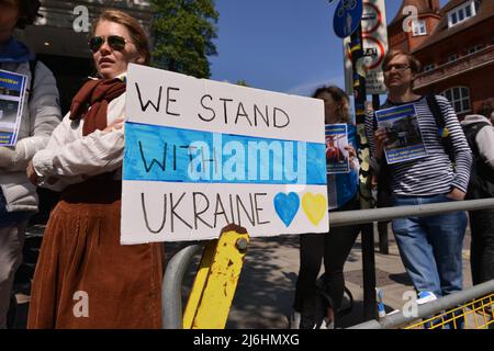Placard with slogan We Stand With Ukraine is seen at the demonstration. The Russians protested in solidarity with the Russian anti-war movement and for the release of political prisoners, in front of the Russian embassy in London. Stock Photo