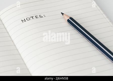 close-up view of pencil on page of notebook with word NOTES Stock Photo