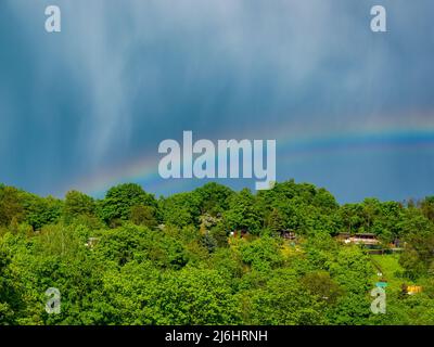 rainbow in a cloudy sky after heavy rain Stock Photo - Alamy