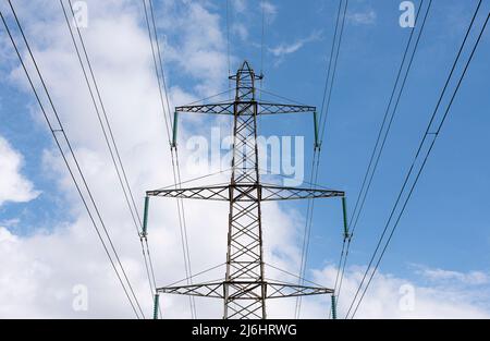 high voltage pole and wires against the blue sky, Denmark, May 1, 2022 Stock Photo