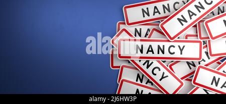 Multiple Nancy city-limit signs on a heap. Nancy is located in the Meurthe-et-Moselle department, France. The typical white city limit sign with a red Stock Photo