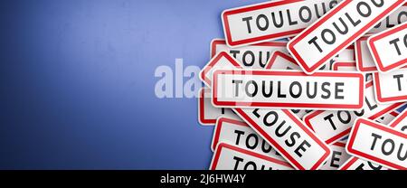 Multiple Toulouse city-limit signs on a heap. Toulouse is located in the Haute-Garonne department, France. The typical white city limit sign with a re Stock Photo