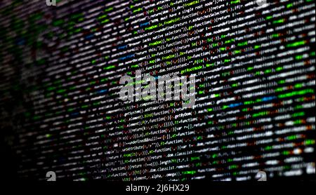 green or white codes on the black computer screen. web developers lifestyle. working for technology. coding to create web sites. digital world. Stock Photo