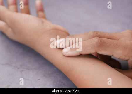 measuring pulse on wrist of hand  Stock Photo