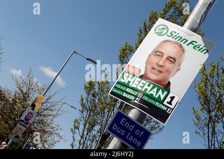 Sinn Fein election poster with smaller parties IRSP (Irish Republican Socialist Party), People before Profit and Aontu election posters in the backgro Stock Photo