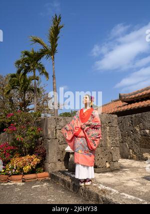 Woman wearing traditional ryusou dress at Okinawa World theme park in ...