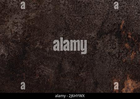 Dark brown bumpy rough surface, iron background with rust. High quality photo Stock Photo