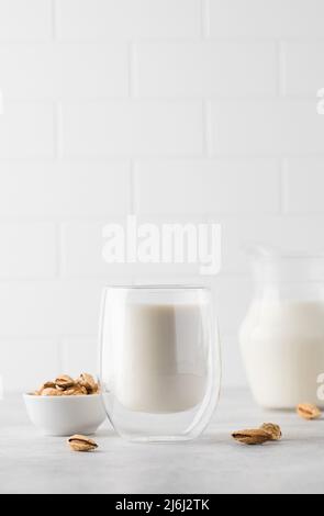 Organic almond milk in a glass on a light background. Alternative to dairy products. Copy space Stock Photo