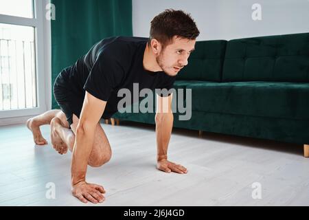 Man doing sport exercise at home Stock Photo