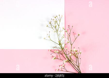 White blank notebook page with copy space for text with little flowers on pastel pink background top view. Empty wedding paper mockup, romantic Valent Stock Photo
