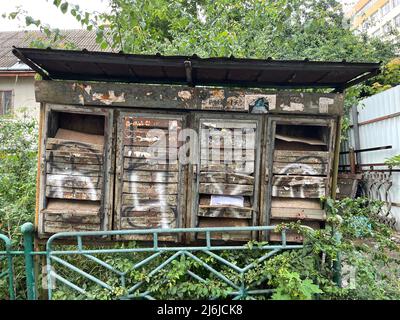 Ivano-Frankivsk, Ukraine - June,2021: Abandoned rusty and crumpled mailboxes with letter in open boxes. Soviet-era postbox painted with graffiti Stock Photo