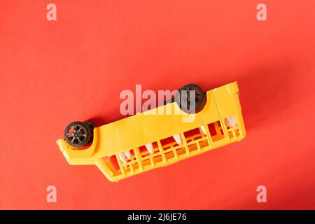 Accident with shcool bus concept. Toy bus upside down Stock Photo