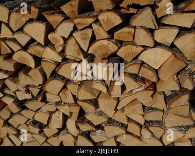 A woodpile in close-up that can be used as a backdrop as a screensaver or background for your own ideas. Norwegian firewood in stacks, stored for sale Stock Photo