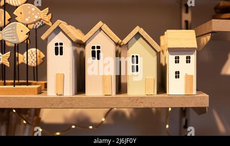 Wooden houses on the shelf, home decor detail. Stock Photo