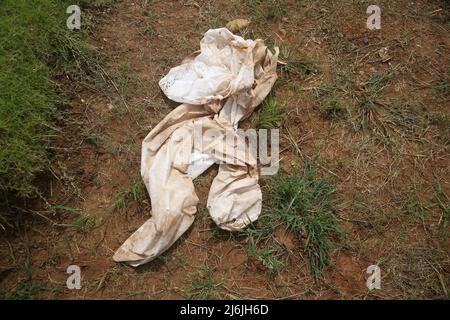 May 2, 2022, Jakarta, Jakarta Capital Special Region, Indonesia: Hazmat clothes on a special grave for Covid-19 victims when a number of residents visit the graves of relatives during the celebration of Eid Al-Fitr 1443 Hijri at the Rorotan Public Cemetery, Cilincing, Jakarta, Indonesia. This year's Eid al-Fitr celebration was used by a number of Muslims to make pilgrimages and pray for their families who had been buried according to the Covid-19 protocol. (Credit Image: © Kuncoro Widyo Rumpoko/Pacific Press via ZUMA Press Wire) Stock Photo