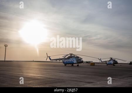 Aktau, Kazakhstan - May 21, 2012: Helicopters on nice blue sky with clouds background. Stock Photo