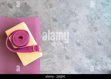 Open yoga mat with cork  block and yoga strap Yoga practice props background. Copy space. Stock Photo