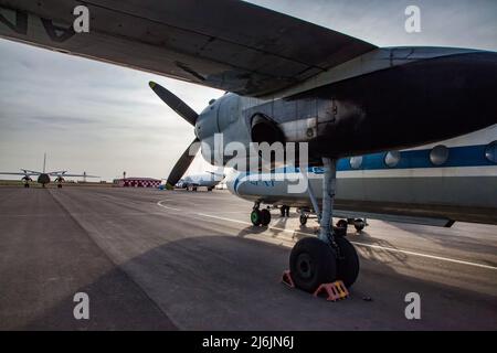 Aktau, Kazakhstan - May 21, 2012: International airport Aktau. Vintage Soviet passenger plane Antonov-24 of SCAT Airlines company on airfield. Blue sk Stock Photo