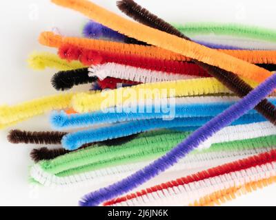 Range of loose Neon colored pipe cleaners on a white background Stock Photo