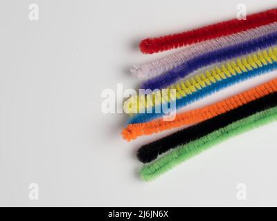 rainbow pipe cleaner ends  on a white background Stock Photo