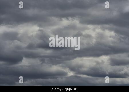 Cloudy sky with rays of sun shining through Stock Photo