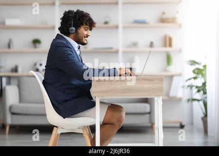 Young indian guy working from home while pandemic, copy space Stock Photo