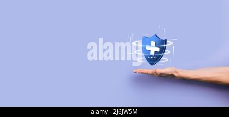 Businessman hold Shield with plus Low polygonal icon, medicine icon.Health shield.Medical logo template,protection symbol with cross sign,healthcare s Stock Photo