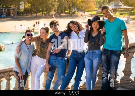 Group of young multiracial students smiling to the camera on some stairs Stock Photo