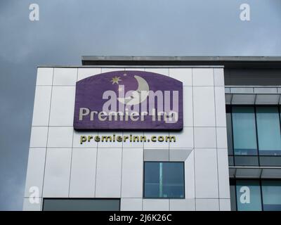 London- April 2022: Premier Inn logo on exterior of hotel in Aldgate, City of   London. The UK's largest hotel chain Stock Photo