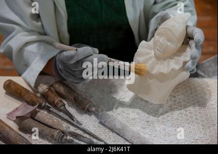 Working on alabaster sculpture. Stock Photo