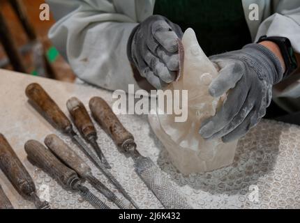 Working on alabaster sculpture. Stock Photo
